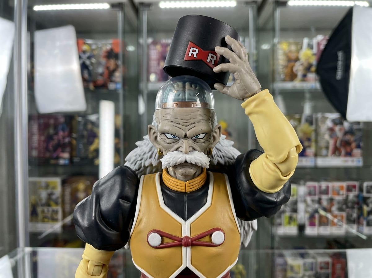 S.H. Figuarts Android 20 figure lifts his RR cap to reveal a transparent brain dome in a professional studio display.